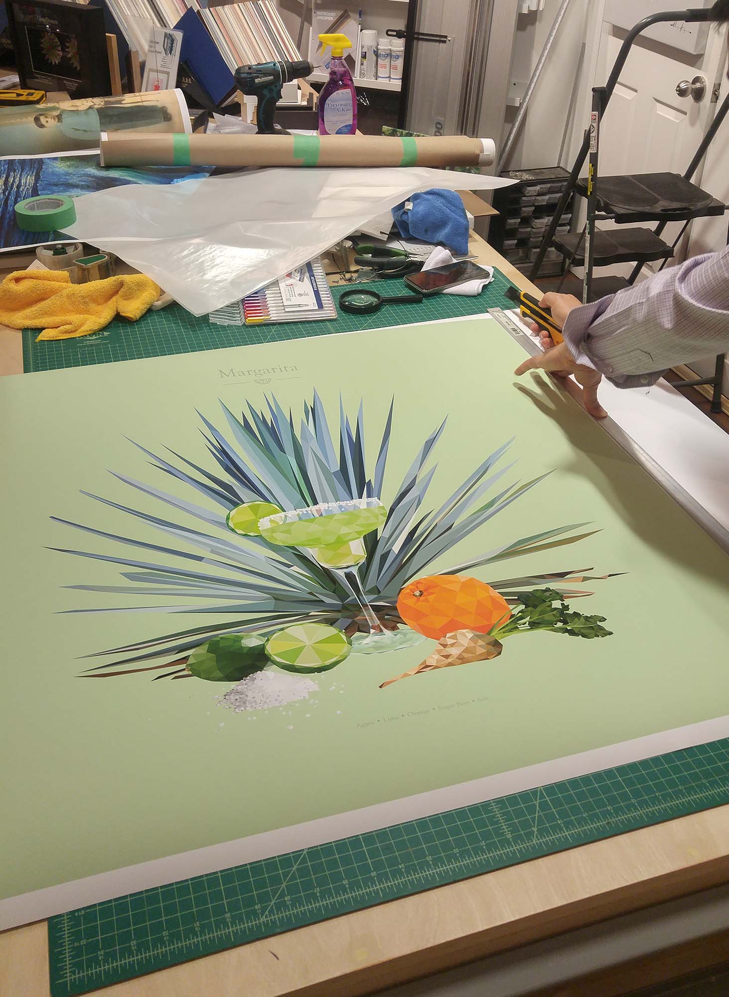 Margarita print being trimmed on a studio cutting mat